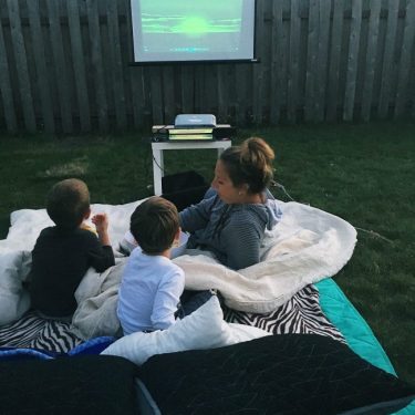 We leave for Maine at the beginning of August, so we only have about a month left of our Summer in Washington! We're filling our weekends with fun and trying to cross some things off our summer bucket list! Ive always wanted to have an outdoor movie night with the kids! So last weekend, we made it happen! We picked a movie they hadn't see yet, we watched The Lion King, the original, the boys LOVED it! They were up dancing around and laughed their butts off at timone and pumba! They watch The Lion Guard occasionally on Disney, so it was kinda fun explaining the difference to them! So steps to the perfect outdoor movie night? have a fire and make s'mores before it gets to dark! We live in the PNW, where it stays light out until about 930-10:00 so we had to keep the kids busy for a couple hours after we put the little babe to bed! We sat around the fire and made s'mores and it was so nice to just have some time with the two older boys! have lots and lots of candy! & popcorn! We took the kids to the store that morning and let them pick out two types of candy each and then that night during the movie, let them just go to town! I kept pushing for more chocolate at the store, but they just werent having it...thennn, the chocolate was the first to go, what do you know? :P set up lots of blankets and pillows and cushions and crawl and get snuggly with your kiddos because its the best thing ever when they snuggle into the crook of your arm or lay their head across your chest